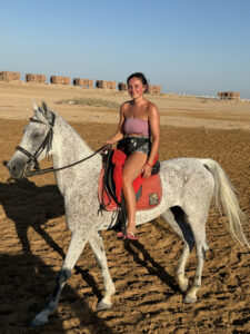 Woman riding a horse in the desert in Hurghada, Egypt.